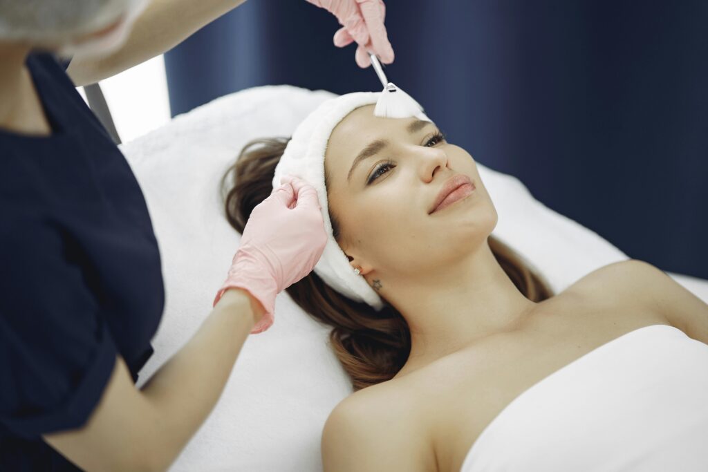 A woman receives a rejuvenating facial treatment at a spa, promoting relaxation and skincare.